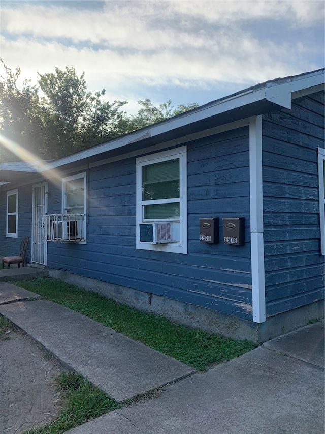 view of side of home featuring cooling unit