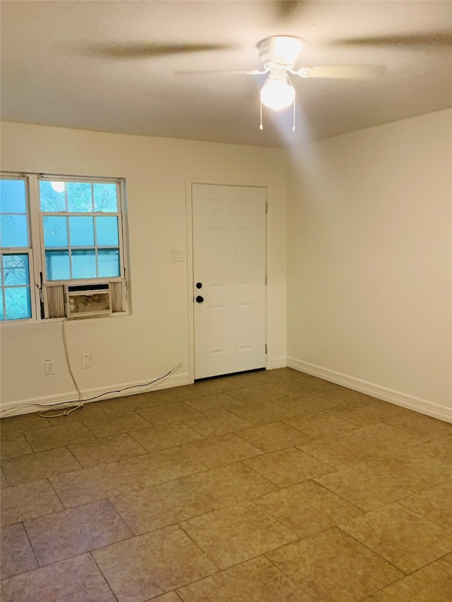 unfurnished room featuring cooling unit and ceiling fan