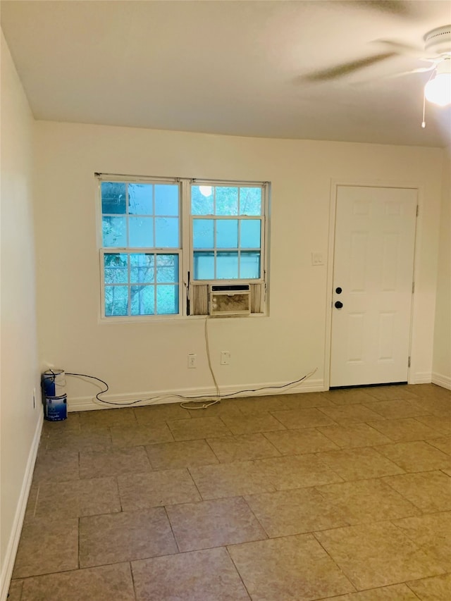 spare room featuring ceiling fan and cooling unit