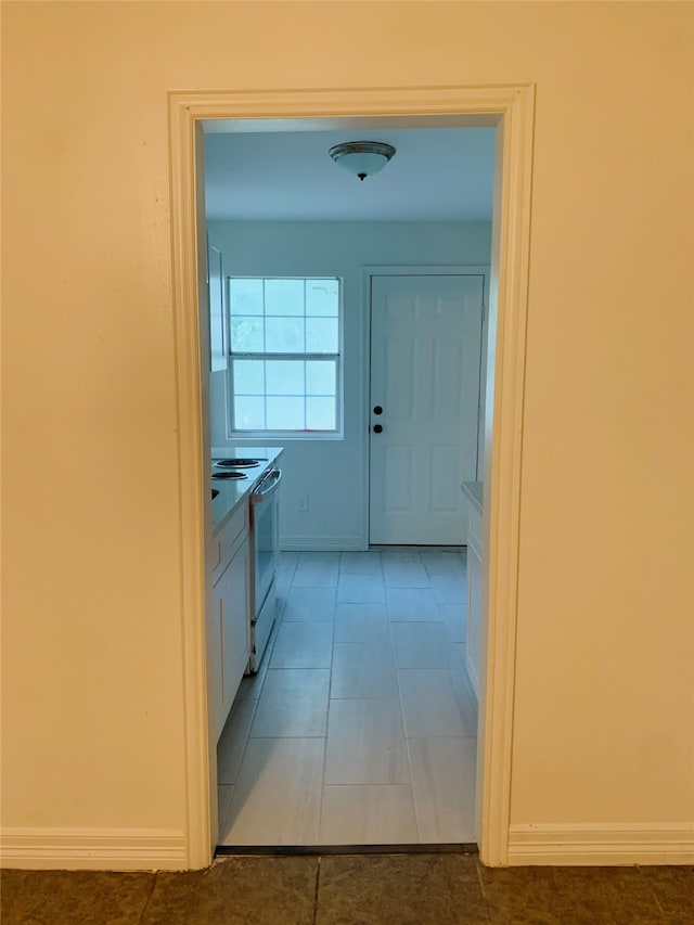 hall featuring light tile patterned flooring