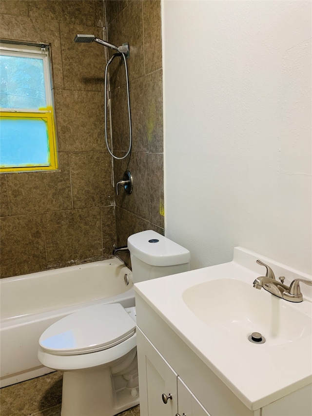 full bathroom with vanity, tiled shower / bath combo, and toilet