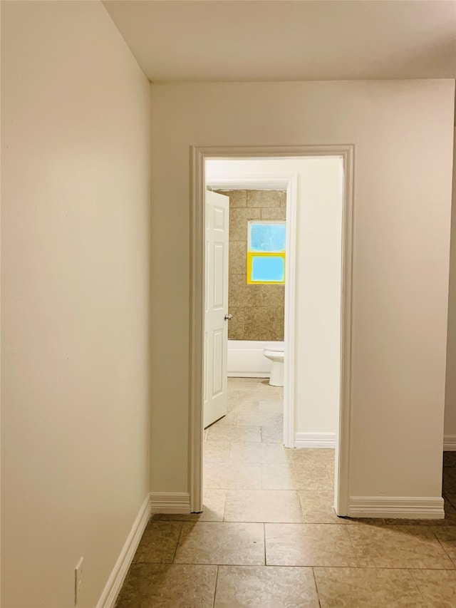 hallway featuring light tile patterned flooring