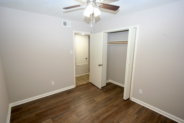 unfurnished bedroom with a closet, ceiling fan, and dark hardwood / wood-style flooring