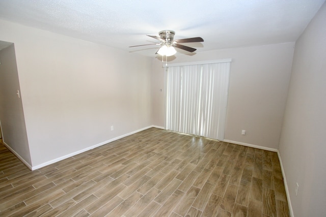 spare room featuring ceiling fan and light hardwood / wood-style flooring