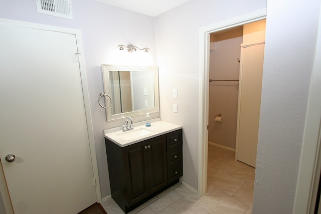 bathroom featuring tile patterned flooring and vanity