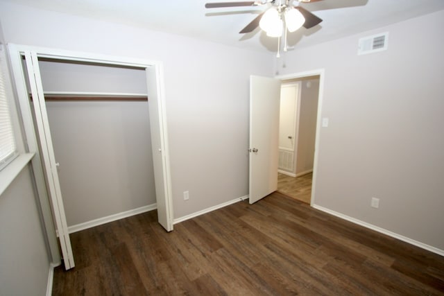 unfurnished bedroom with ceiling fan, a closet, and dark hardwood / wood-style flooring