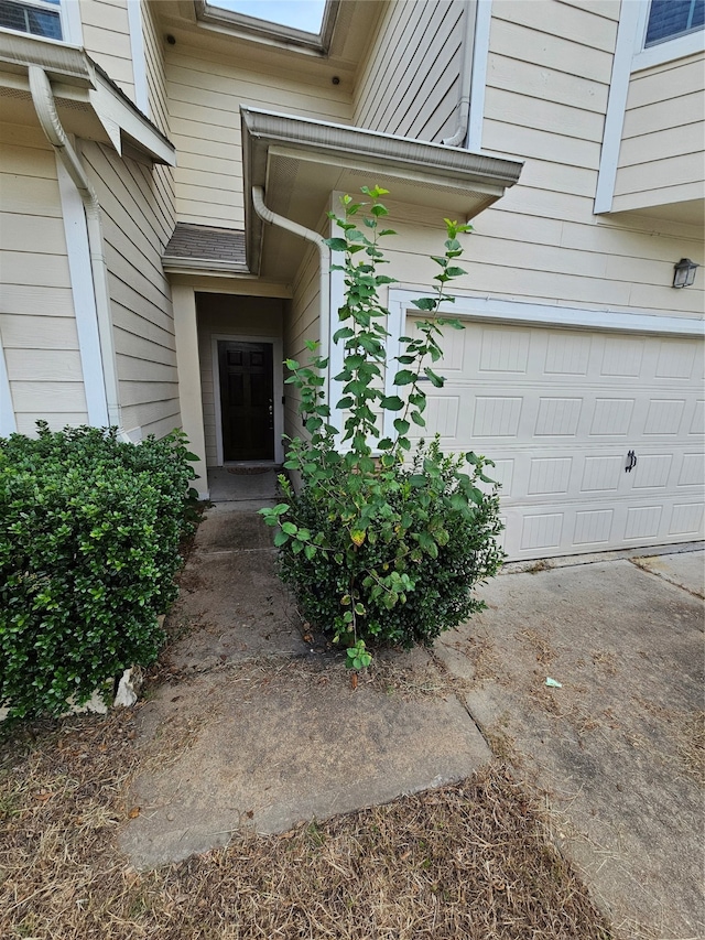 doorway to property with a garage