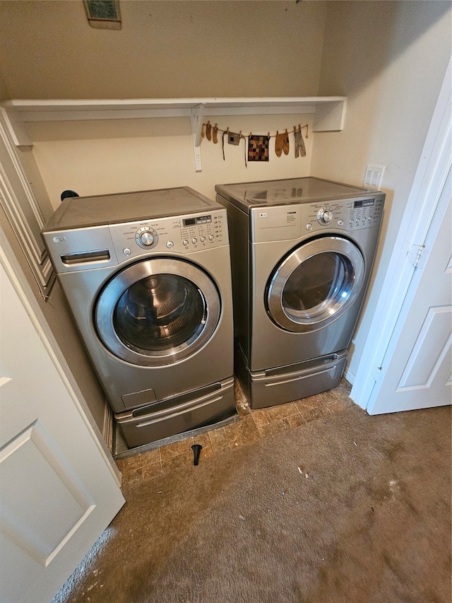 washroom featuring dark carpet and washer and dryer