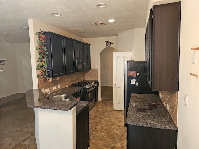 kitchen featuring sink, kitchen peninsula, tasteful backsplash, and black appliances