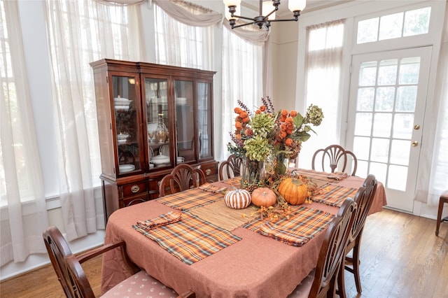 dining room featuring light wood-type flooring and a chandelier