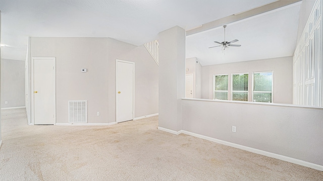 carpeted spare room featuring ceiling fan and lofted ceiling