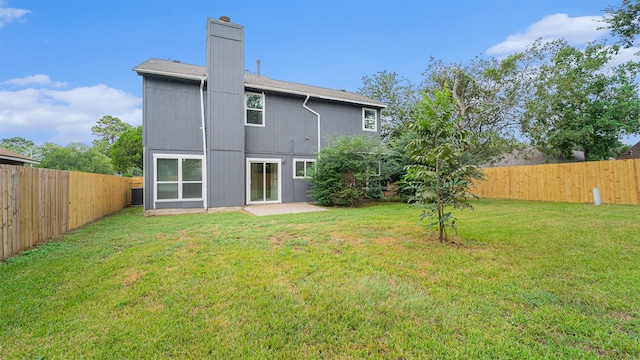 rear view of property with a patio and a yard