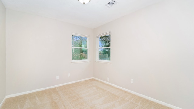 empty room featuring light carpet