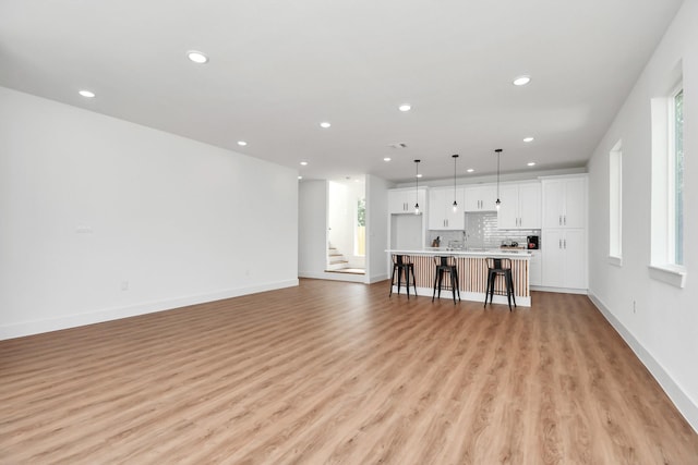 unfurnished living room featuring light wood-type flooring