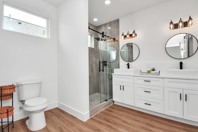 bathroom featuring hardwood / wood-style floors, vanity, toilet, and walk in shower