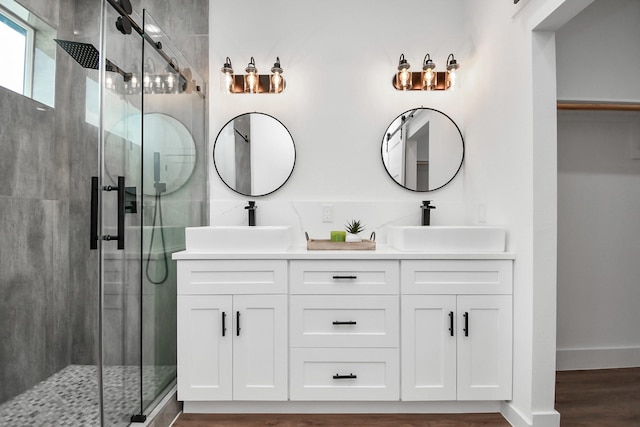 bathroom featuring hardwood / wood-style floors, vanity, and walk in shower