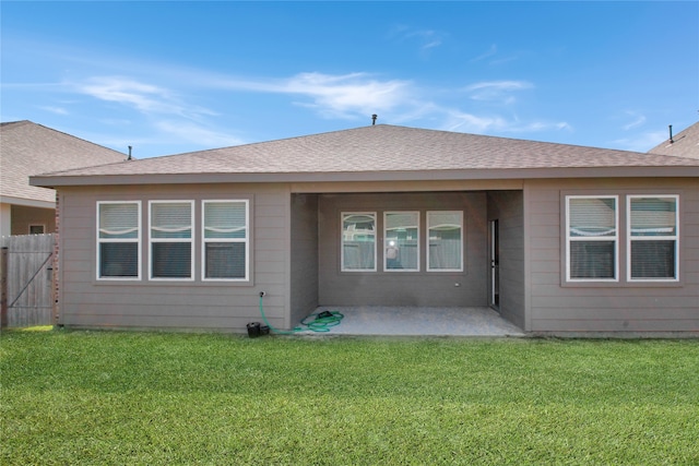 rear view of house with a patio area and a lawn