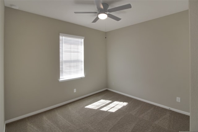 carpeted empty room featuring ceiling fan