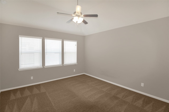 carpeted empty room with ceiling fan and plenty of natural light