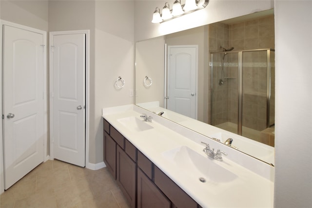 bathroom with vanity, a shower with shower door, and tile patterned floors