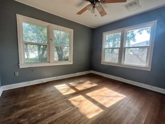 empty room featuring ceiling fan and dark wood-type flooring