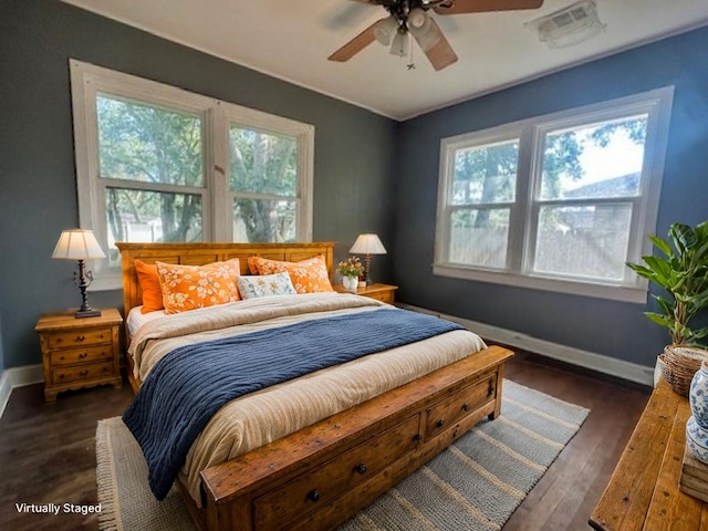 515 Breezy Ln, Wharton, TX 77488 - bedroom featuring multiple windows, baseboards, wood finished floors, and a ceiling fan