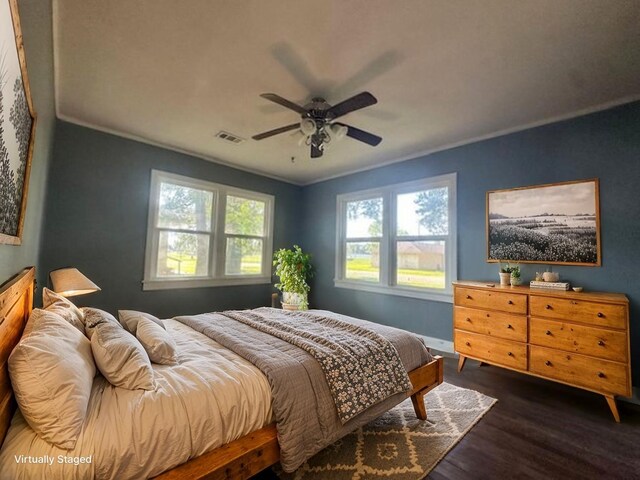 515 Breezy Ln, Wharton, TX 77488 - bedroom with dark wood-style flooring, a ceiling fan, crown molding, and baseboards