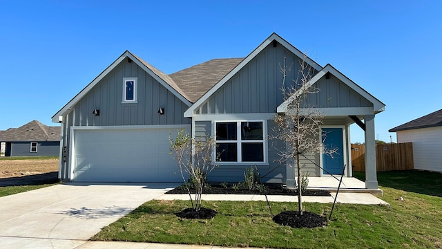 view of front of property featuring a garage and a front yard