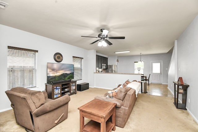 carpeted living room with ceiling fan