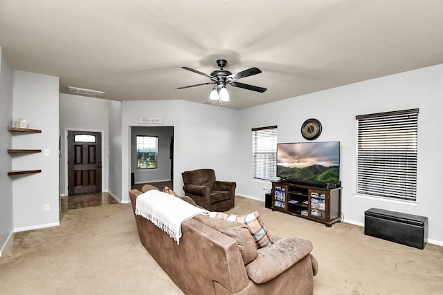 carpeted living room with ceiling fan