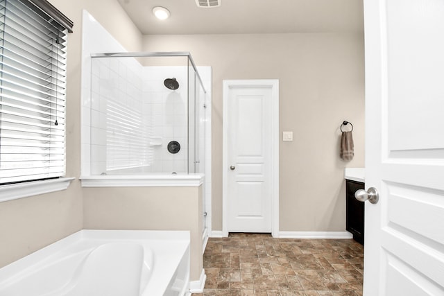 bathroom featuring plus walk in shower and vanity