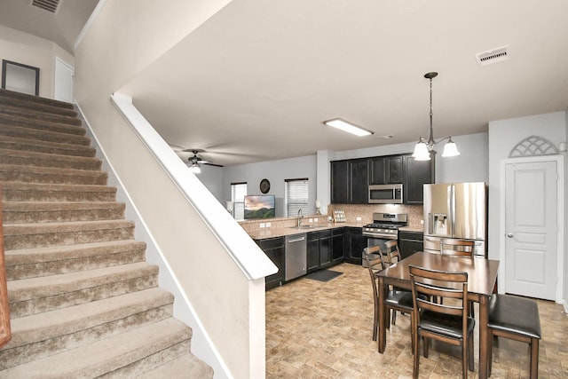 interior space with ceiling fan with notable chandelier and sink