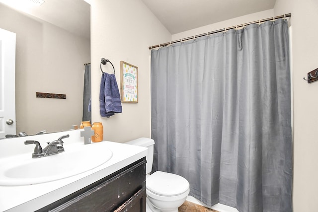 bathroom with tile patterned flooring, walk in shower, vanity, and toilet