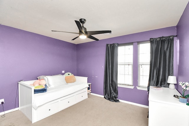 bedroom featuring light carpet and ceiling fan