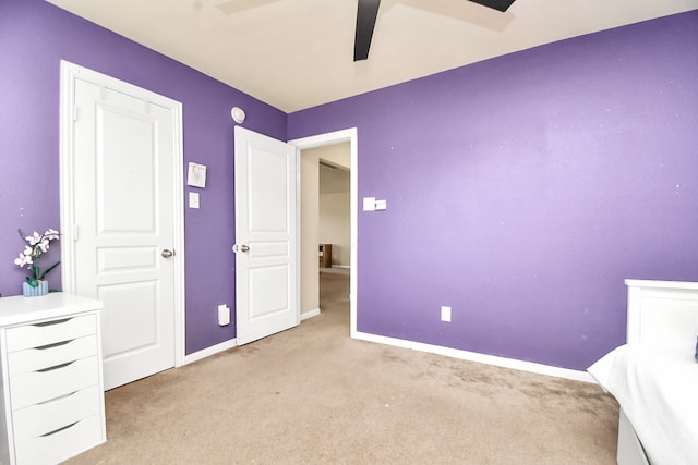 unfurnished bedroom featuring light carpet and ceiling fan