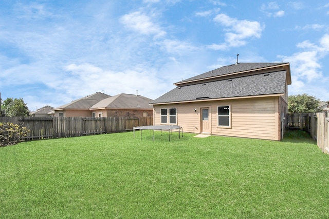 back of property featuring a lawn