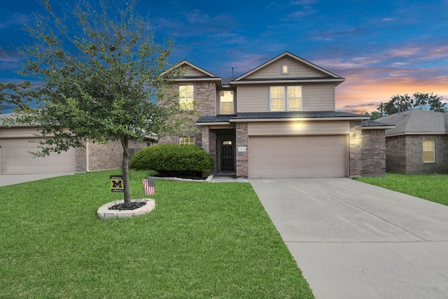 view of front of home featuring a garage and a lawn