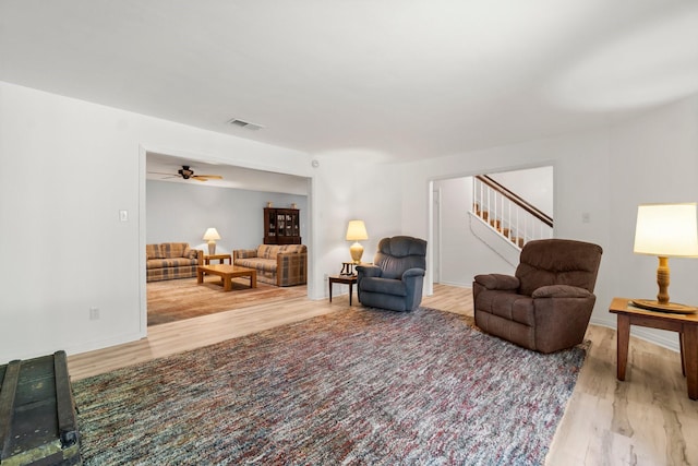 6711 River Lodge Dr, Spring, TX 77379 - living area featuring ceiling fan, visible vents, wood finished floors, stairway, and baseboards