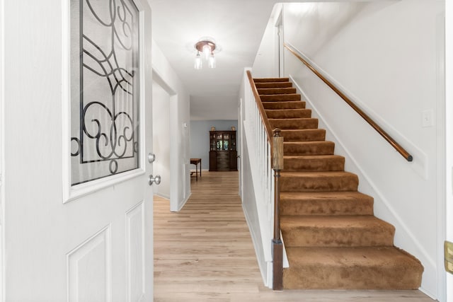 staircase featuring hardwood / wood-style floors