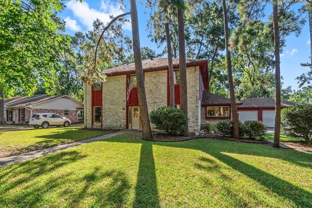 6711 River Lodge Dr, Spring, TX 77379 - view of front of home with an attached garage, a front lawn, and brick siding