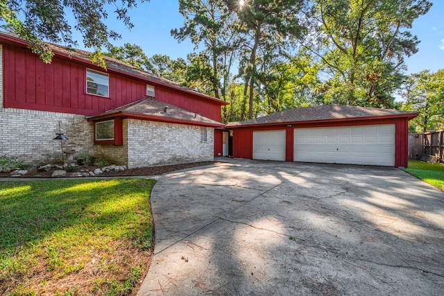 view of property exterior with a garage and a lawn