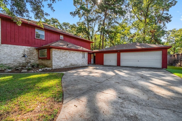 6711 River Lodge Dr, Spring, TX 77379 - view of front of home with an attached garage, brick siding, a front yard, concrete driveway, and an outdoor structure