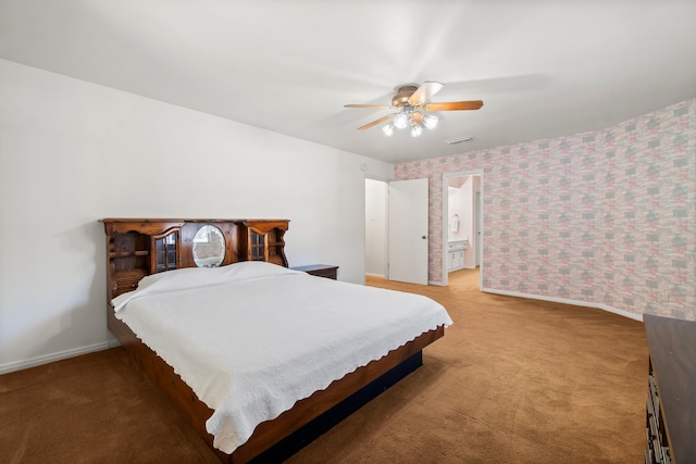 carpeted bedroom featuring ensuite bath and ceiling fan