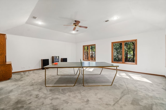 game room with a raised ceiling, carpet flooring, and ceiling fan