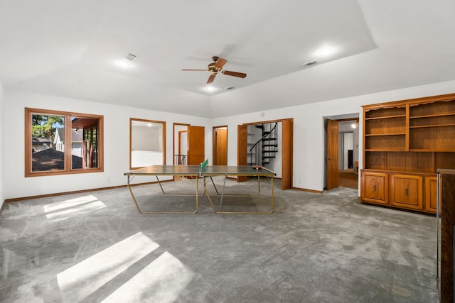 interior space featuring carpet floors, a tray ceiling, and ceiling fan