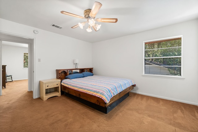 bedroom featuring light colored carpet and ceiling fan