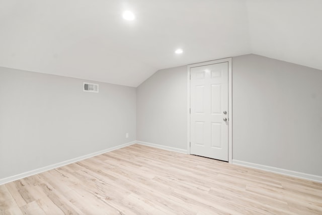 bonus room featuring lofted ceiling and light wood-type flooring