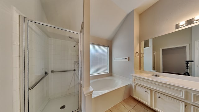 bathroom with vaulted ceiling, independent shower and bath, vanity, and tile patterned floors