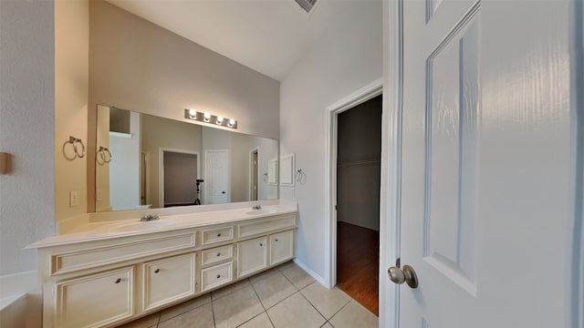 bathroom featuring lofted ceiling, tile patterned flooring, and vanity