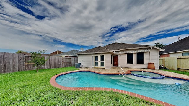 view of pool featuring central AC unit, a yard, and an in ground hot tub